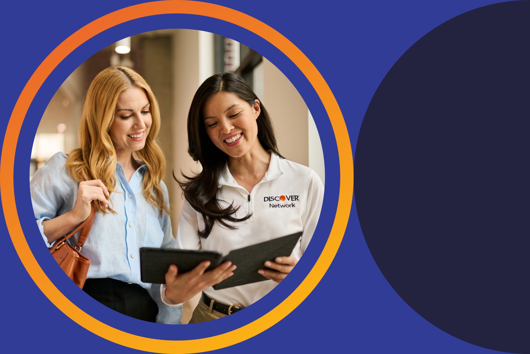two women collaborating looking at tablet device