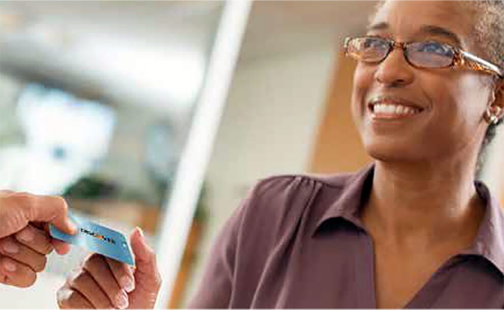 woman handing over discover card