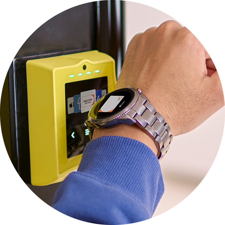 Customer pays using smartwatch on NFC terminal.