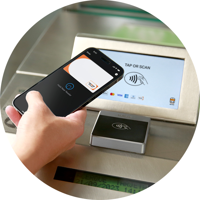 Hand holding a smartphone to pay at a terminal