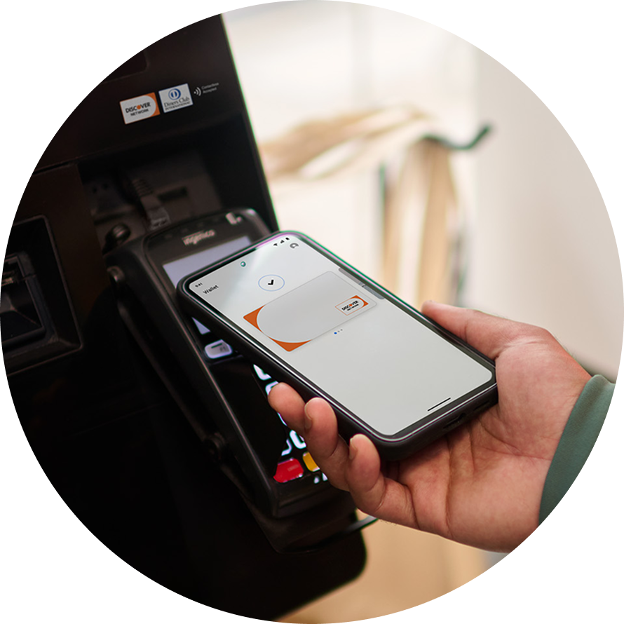Hand holding a smartphone to make a contactless payment