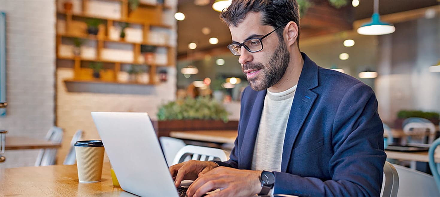 man at cafe on laptop